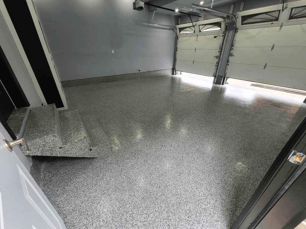 Freshly coated flake epoxy garage floor in a residential home in Hamilton, Ontario