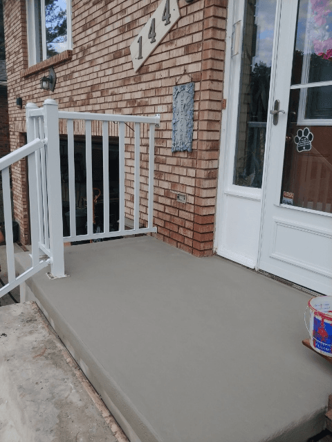 Freshly resurfaced front porch concrete steps and landing on a residential home in Hamilton, Ontario