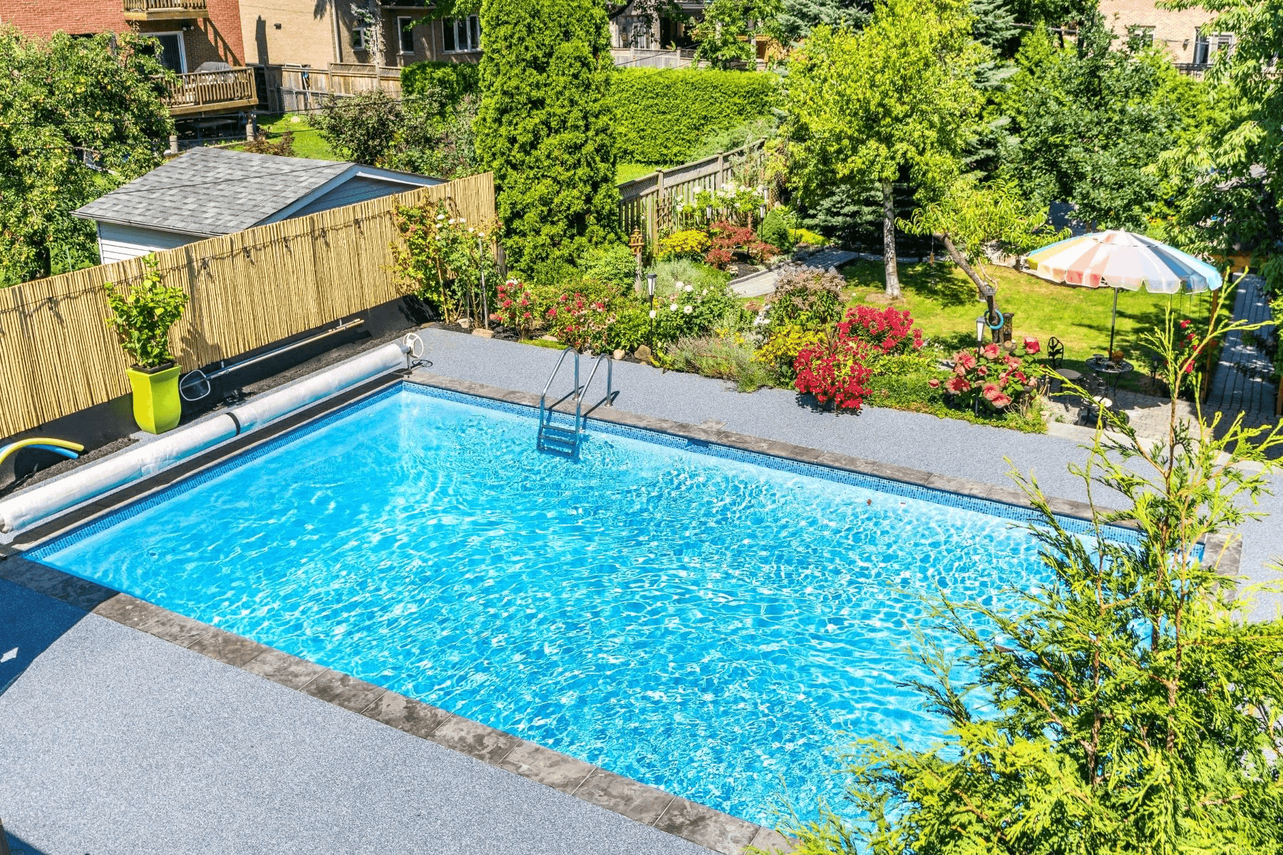Rubberkrete soft rubber resurfacing applied around an inground pool in a Hamilton, Ontario backyard